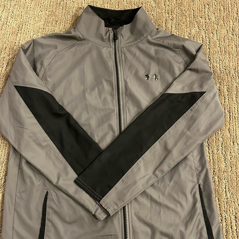 Kids Under Armour windbreaker/raincoat, gray and black, full zip with pockets.
